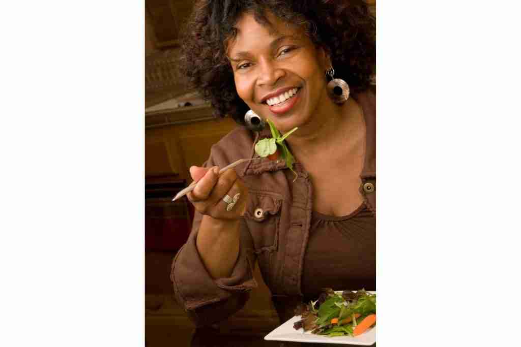 Elegant older black lady eating dementia friendly foods