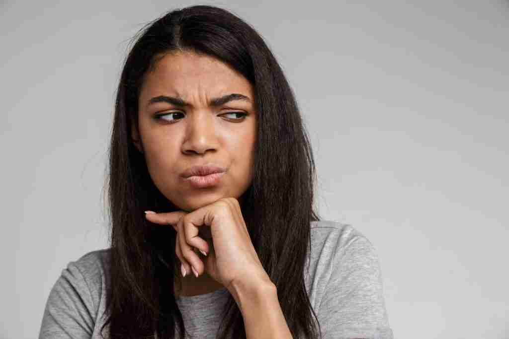 Black lady looking puzzled about some common misconceptions fibroids she has heard
