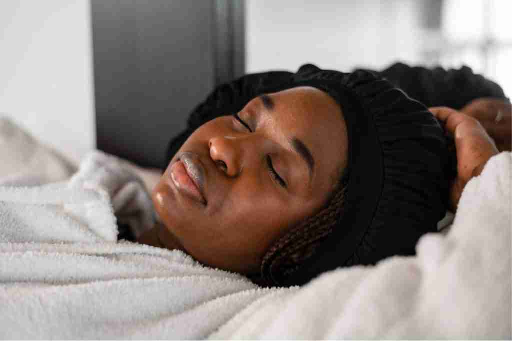 Black woman in black bonnet fast asleep