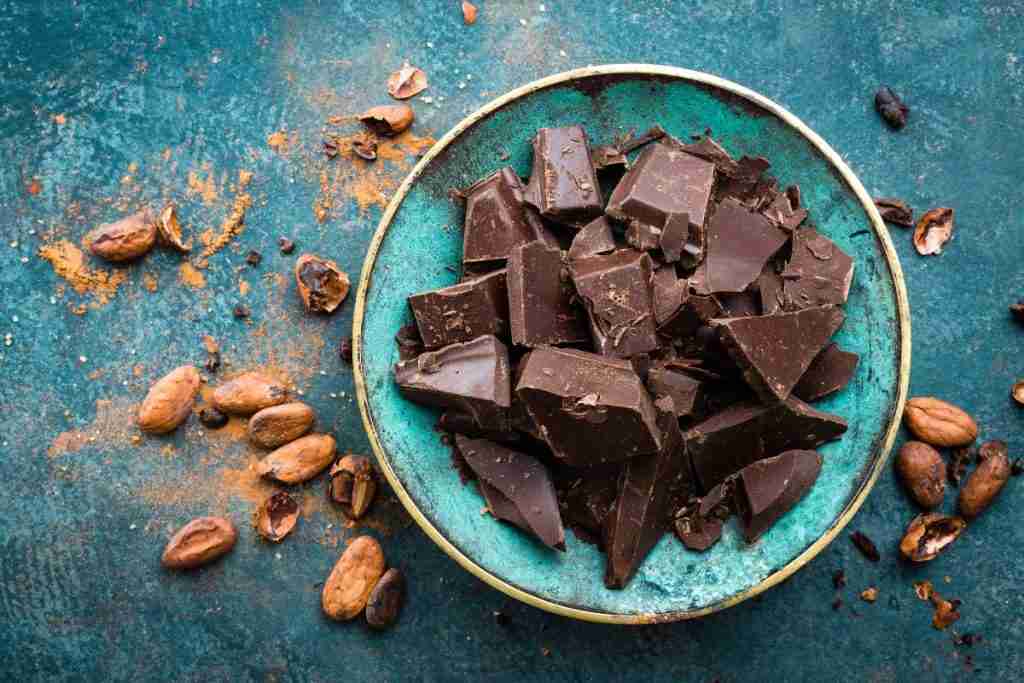 Green bowls of pieces of dark chocolate - eating small amounts helps to boost your endorphins