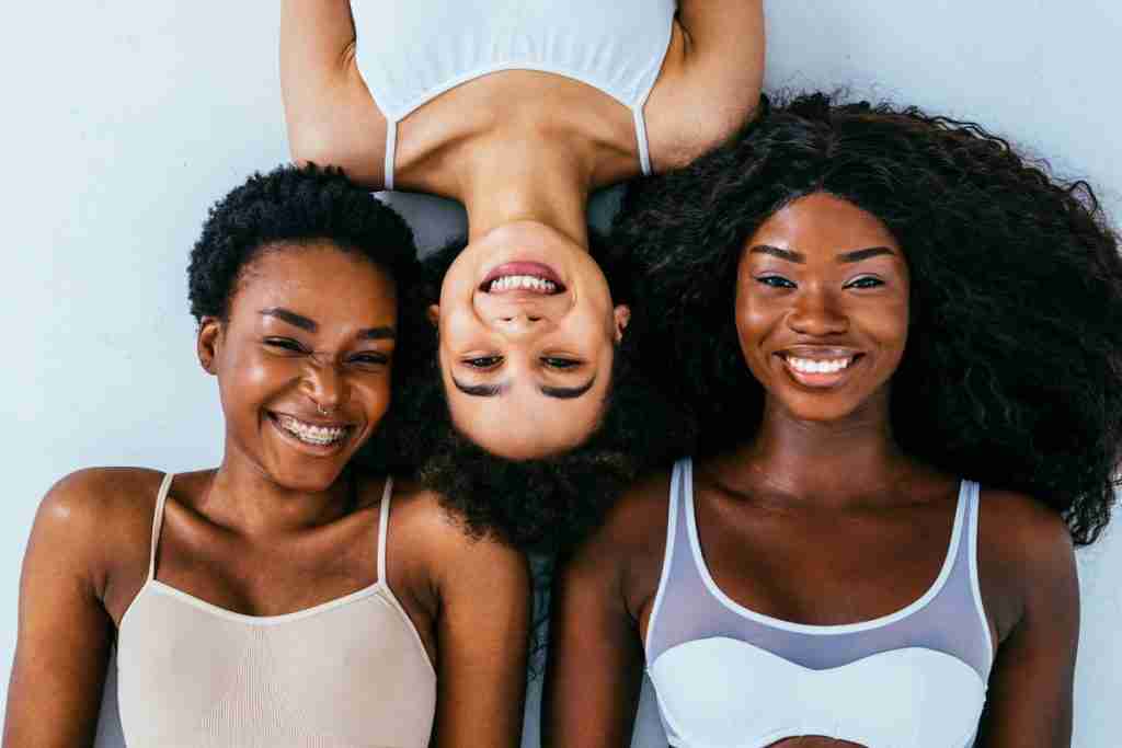 Women of different ages smiling at the camera.