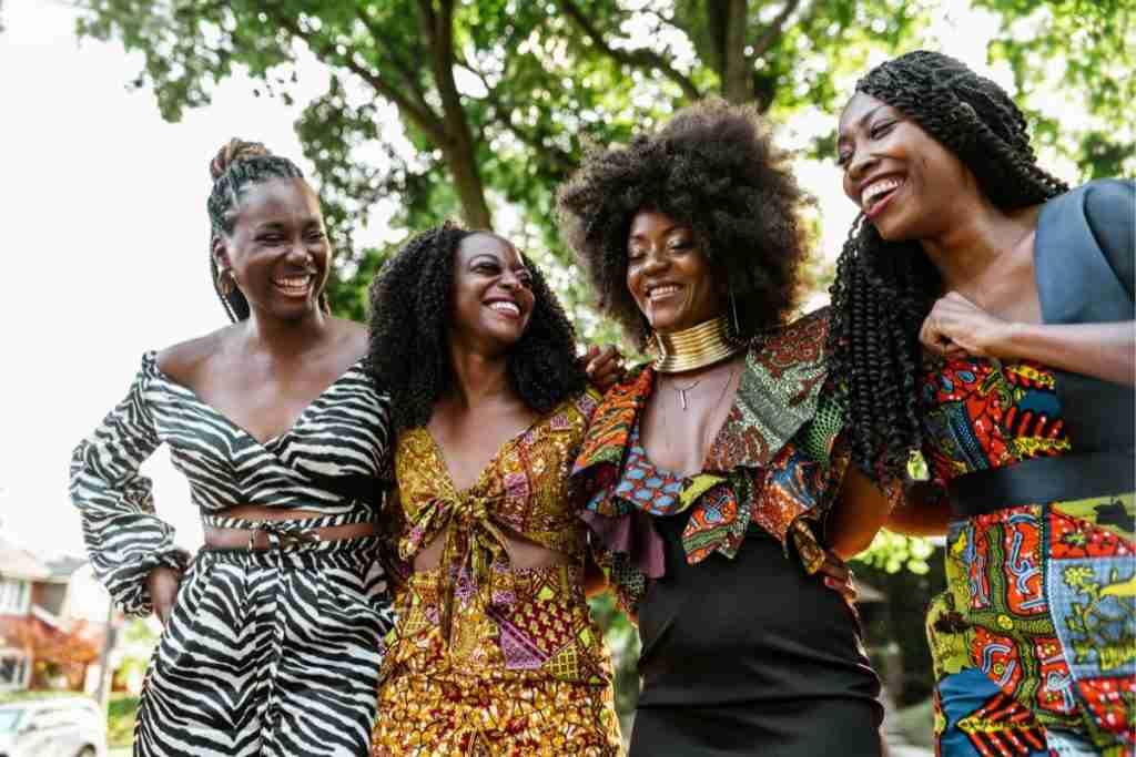 Four black women of of different ages laughing on a day out