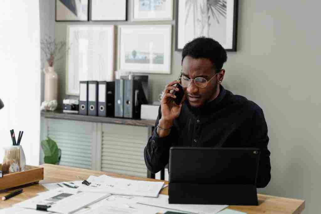 Black man working on the laptop while listening to his partner and doing research on treatment options is a goal of male perspective in fibroids