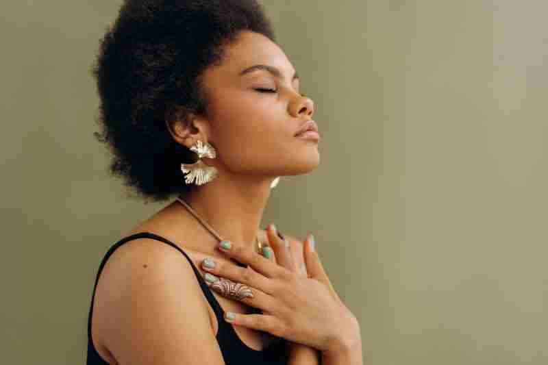 young black lady in repose, meditation is one of the forms of wellness in 2024