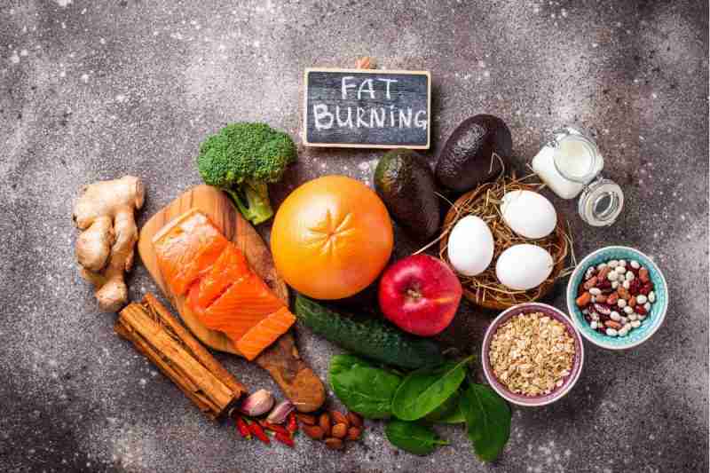 Ways to lose weight image showing a selection of natural foods - methods include avoiding processed foods and adding sugar