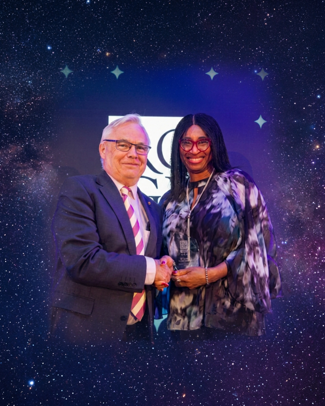 AskAwayHealth Founder Dr Sylvia Kama-Kieghe receives the RCGP 2026 Digital Champion Award, shaking hands with Professor Sir Sam Everington OBE, President of the RCGP, against a purple-lit backdrop.